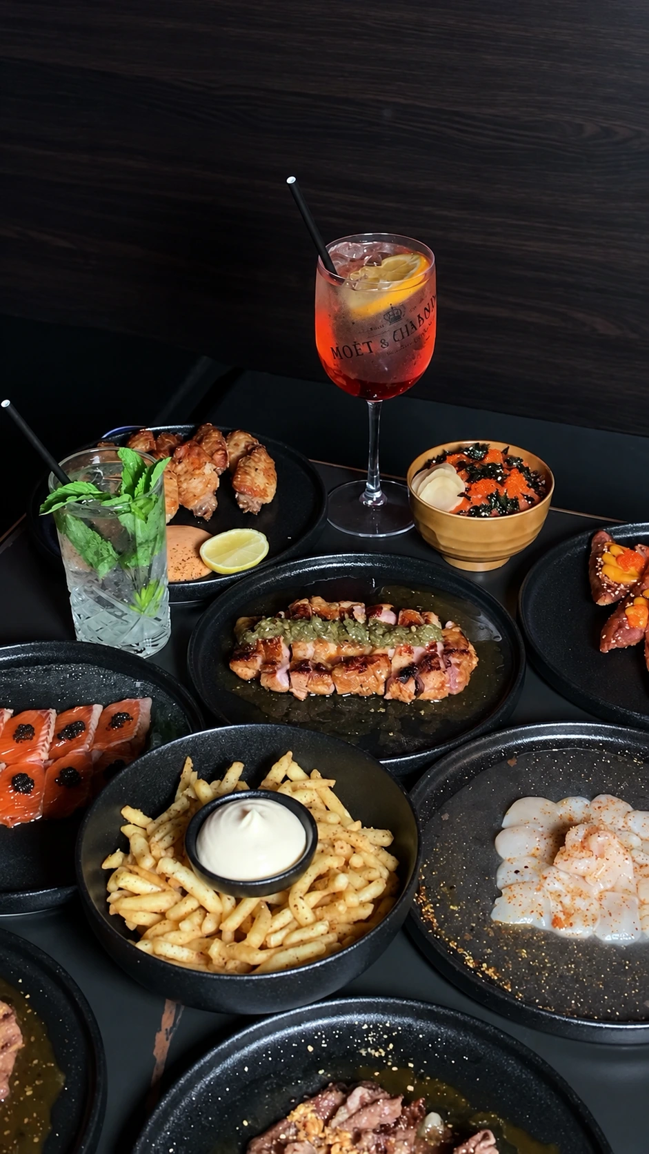 A table of shared dishes and drinks at Jaya