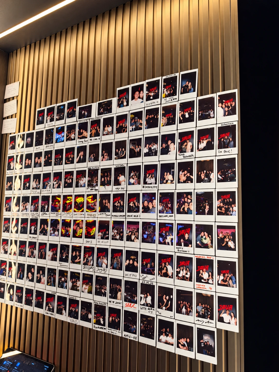 A wall of guest photographs and memories at Jaya